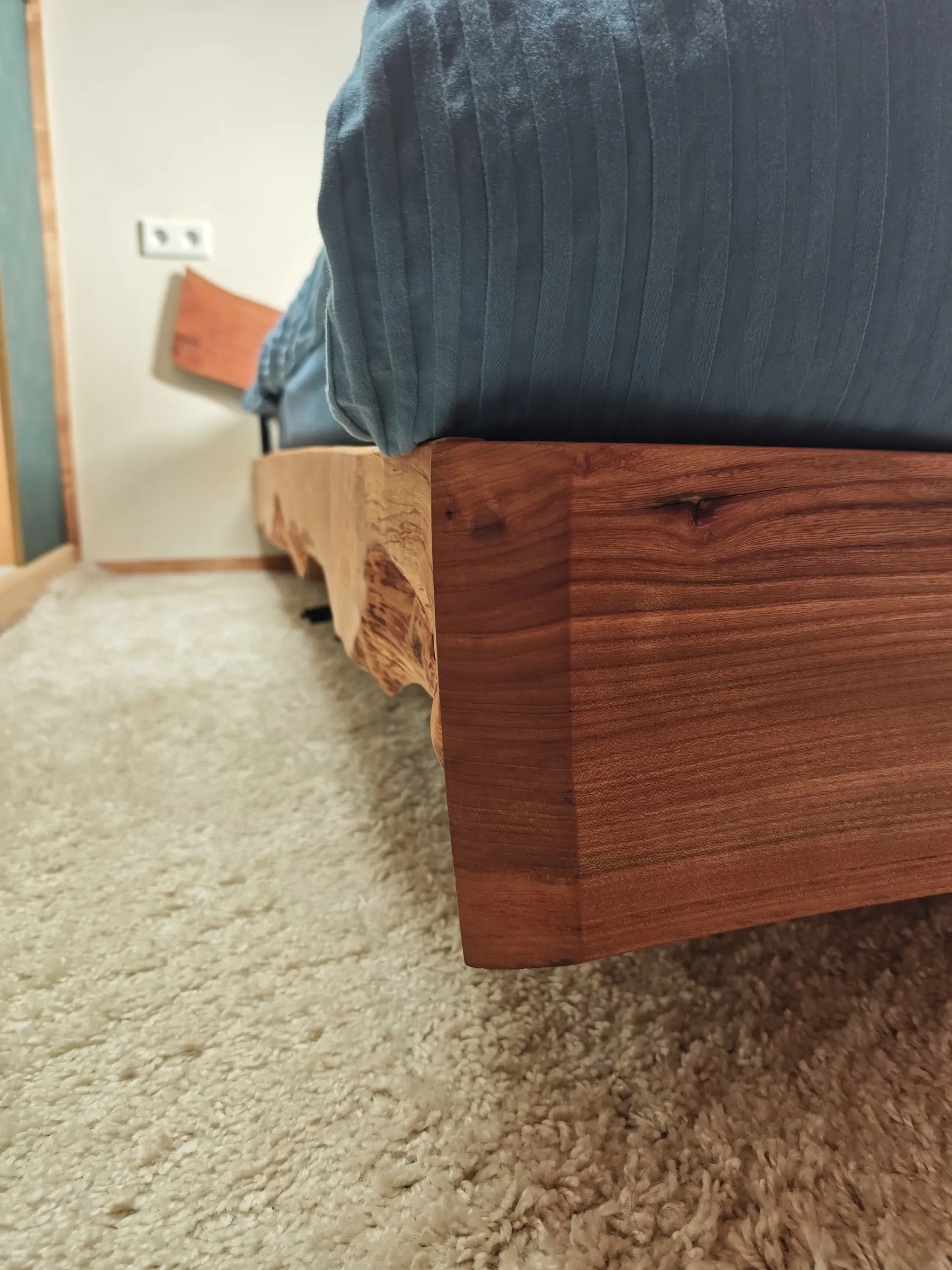 Hoek van het bedframe op het tapijt